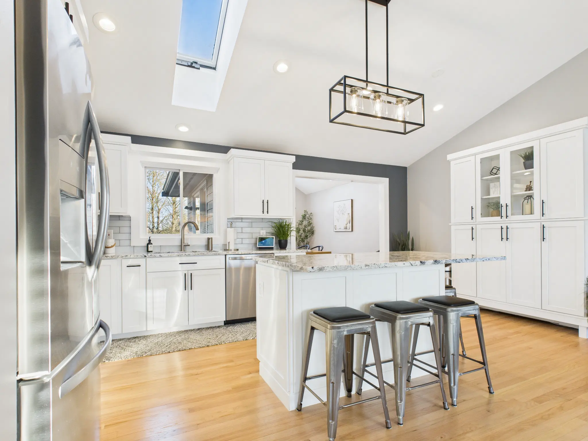 Professional HDR photography of modern kitchen with white cabinets and granite countertops in Rhode Island home